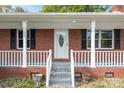 Close-up of front porch area with white railing and front door with decorative oval window at 1195 Ralph B Keener Rd, Lincolnton, NC 28092