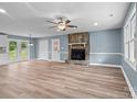 Open living space with wood-look floors, stone fireplace, and natural light at 1195 Ralph B Keener Rd, Lincolnton, NC 28092