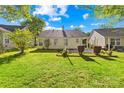 Spacious backyard with lush green grass and mature landscaping, great for outdoor activities at 12305 Portrush Ln, Charlotte, NC 28273