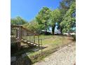 View of wooden deck and backyard, which includes a chain link fence for containment at 1307 Washington Ln, Kannapolis, NC 28083