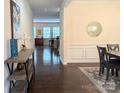 An inviting dining room featuring hardwood floors, chandelier, and a round mirror accent at 132 Cherry Bark Dr, Mooresville, NC 28117