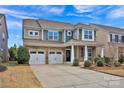 Charming two-story home with stone accents, manicured landscaping, and a two-car garage at 132 Cherry Bark Dr, Mooresville, NC 28117