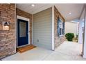 A welcoming front porch with stone accents, leading to a paneled front door at 132 Cherry Bark Dr, Mooresville, NC 28117