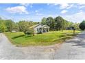 Inviting home surrounded by lush greenery and a spacious yard with mature trees at 146 37Th Nw St, Hildebran, NC 28601
