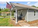 Cozy front porch with seating, perfect for enjoying peaceful moments outdoors with an American flag at 146 37Th Nw St, Hildebran, NC 28601