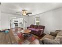 Comfortable living room with hardwood floors, ceiling fan, and an open view to the kitchen at 146 37Th Nw St, Hildebran, NC 28601