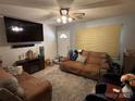 Cozy living room featuring comfortable seating, a large TV, and a welcoming front door at 22 Heritage View Rd, Hickory, NC 28601