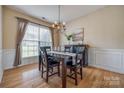 Elegant dining room with a chandelier, hardwood floors, and wainscoting details at 269 Tradition Way, Rock Hill, SC 29732