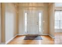 Bright foyer with hardwood floors, white door, sidelights, and transom window at 269 Tradition Way, Rock Hill, SC 29732
