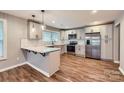 Modern kitchen featuring stainless steel appliances, white cabinets, and sleek countertops with peninsula bar at 2924 Parkway Ave, Charlotte, NC 28208