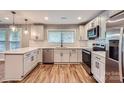 Well-lit kitchen showcases stainless steel appliances, white subway tile backsplash and white cabinets at 2924 Parkway Ave, Charlotte, NC 28208