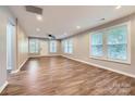 Spacious, light-filled living room with new hardwood floors and neutral paint, ready for your personal touch at 2924 Parkway Ave, Charlotte, NC 28208
