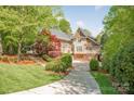 Beautiful exterior of a home with lush landscaping and a long driveway at 3201 Oak Brook Dr, Waxhaw, NC 28173