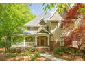 Charming front exterior with a welcoming porch and beautifully landscaped front yard with flower beds at 3201 Oak Brook Dr, Waxhaw, NC 28173