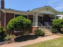 Beautiful brick home with a welcoming front porch, decorative columns, and well-maintained landscaping at 351 Glenwood Dr, Mooresville, NC 28115