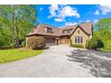 Beautiful home with a stone and siding exterior, mature landscaping, and a wide driveway at 401 Yorkfield Dr, Shelby, NC 28150