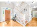 Bright foyer features hardwood floors, staircase, and natural light from the front door and transom windows at 401 Yorkfield Dr, Shelby, NC 28150