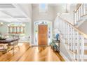 Bright foyer features a hardwood floor and a staircase with white risers and wood handrail at 401 Yorkfield Dr, Shelby, NC 28150