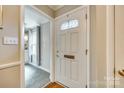 Welcoming foyer featuring a white front door with a leaded glass window and a view into the kitchen at 4607 Hedgemore Dr # H, Charlotte, NC 28209
