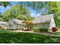 Expansive backyard featuring lush green grass, mature trees and healthy landscape at 4931 Pine Ridge Rd, Charlotte, NC 28226