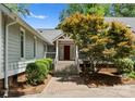 Inviting front entrance with a red door, complemented by a beautifully landscaped walkway and garden at 4931 Pine Ridge Rd, Charlotte, NC 28226