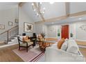 Stylish living room with high ceilings, modern lighting, and comfortable seating by the front door at 4931 Pine Ridge Rd, Charlotte, NC 28226