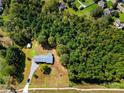Expansive aerial view of home on lot with wooded surroundings offering privacy and seclusion at 5303 Rogers Rd, Monroe, NC 28110