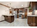 Well-equipped kitchen with granite countertops, stainless steel appliances, and dark wood cabinetry at 5303 Rogers Rd, Monroe, NC 28110