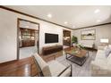 Inviting living room with wood floors, modern furniture, and neutral color scheme at 5303 Rogers Rd, Monroe, NC 28110