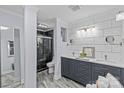 Stylishly renovated bathroom with dual sinks, modern tile accents, a sleek shower, and elegant fixtures at 6035 Idlebrook Dr, Charlotte, NC 28212