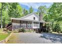 Charming home featuring a stone chimney, screened porch and lovely landscaping at 729 Lochaven Rd, Waxhaw, NC 28173
