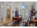 Elegant living room with large windows, hardwood floors, and a decorative rug at 7815 Scottsburg Ct, Mint Hill, NC 28227