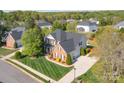 An aerial view of a home showing a lush lawn, a side entry two-car garage and mature trees at 8014 Avanti Dr, Marvin, NC 28173