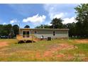 View of back exterior with sliding glass door leading to wooden deck at 828 Long Bow Rd, Salisbury, NC 28144