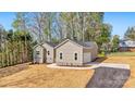 A charming single-story home with fresh landscaping, a driveway, an attached garage, and mature trees at 9165 Cherokee Dr, Hickory, NC 28601