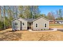 A single-story house with a freshly seeded lawn, landscaping, and natural surroundings at 9165 Cherokee Dr, Hickory, NC 28601