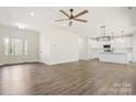 Spacious living room features an open floor plan, hardwood floors, modern lighting, and access to the kitchen at 9165 Cherokee Dr, Hickory, NC 28601