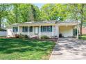 Inviting single-story brick home featuring a covered front porch and an attached carport on a sunny day at 1 Horace Grigg Cir, Shelby, NC 28152