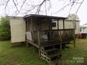 View of the home's covered porch and siding with green lawn area at 107 N Rudisill Ave, Cherryville, NC 28021