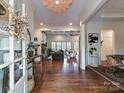 Spacious foyer with hardwood floors, leading to the living room with a stone fireplace at 1126 Concord Rd, Davidson, NC 28036