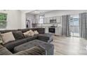 Inviting living room with an open floor plan, seamlessly connecting to the kitchen at 113 Mcgill Nw Ave, Concord, NC 28025
