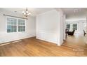 Open dining room featuring hardwood floors, wainscoting, and natural light at 1176 Shiloh Bend Trl, Fort Mill, SC 29715