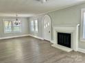 Bright living room featuring modern flooring, fireplace, and a unique arched door at 121 W 11Th St, Oakboro, NC 28129