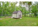 Spacious backyard featuring a storage shed with double doors, providing ample space for outdoor storage at 1222 Glenarden Dr, Rock Hill, SC 29730