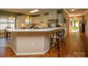 Bright kitchen features white cabinets, stainless steel appliances and breakfast bar seating at 12435 Mallard Dr, Charlotte, NC 28269