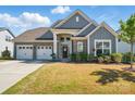 Beautiful home showcasing a three-car garage, stone accents, and a welcoming front entrance at 12512 Journeys End Trl, Huntersville, NC 28078
