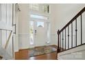 Bright foyer with hardwood floors, wainscoting and a staircase with wooden railing at 12512 Journeys End Trl, Huntersville, NC 28078