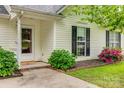 Close-up of the front porch, showing the entrance, lush landscaping, and covered entryway at 1252 Spring View Ct, Rock Hill, SC 29732