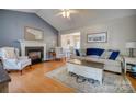 Bright living room with a fireplace, vaulted ceiling, and hardwood floors at 1252 Spring View Ct, Rock Hill, SC 29732