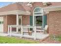 Cozy front porch featuring a white railing, wooden bench, chairs, and tasteful decor at 1280 Willowbreeze Sw Ct, Concord, NC 28025